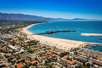 general shot image of a beach with blue water and yellow sand