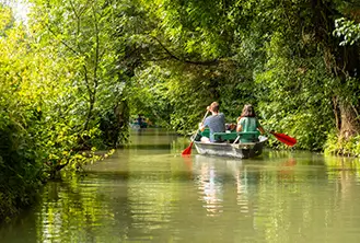 couple sails a boat on a lake