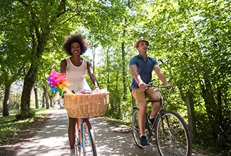 couple riding bicycle outdoors