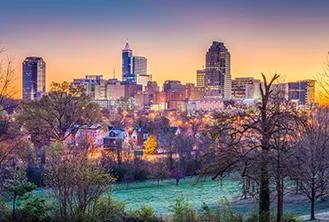 photograph of an illuminated city under a sunset