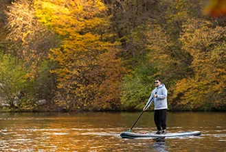 man sailing alone in a canoe in a lagoon