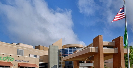 beige and brown building next to a flag of the united states