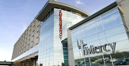 glass building showing two signs on the