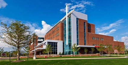 white brick building with a giant cross at the entrance