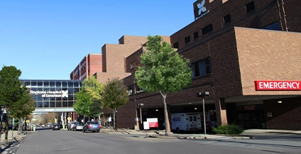daytime image showing a building with a red emergency sign