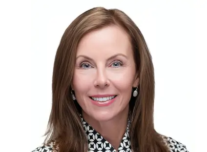 Headshot of Amy Katnik smiling, wearing a black and white blouse.