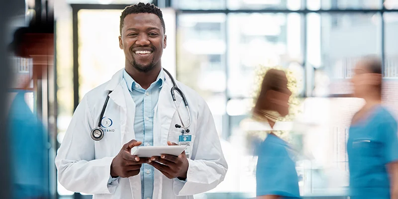 Close-up of a physician in a white lab coat smiling
