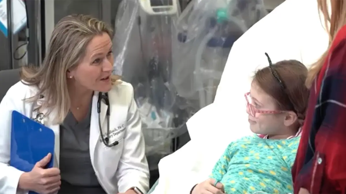 A closeup of a medical professional speaking to a young patient