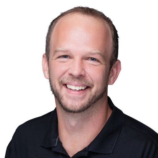 Headshot of Jon Winters, Smiling, wearing a black collared polo