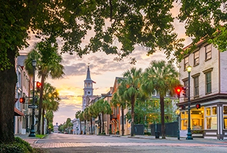 Historic pastel-colored buildings during sunset in downtown Charleston, south Carolina.